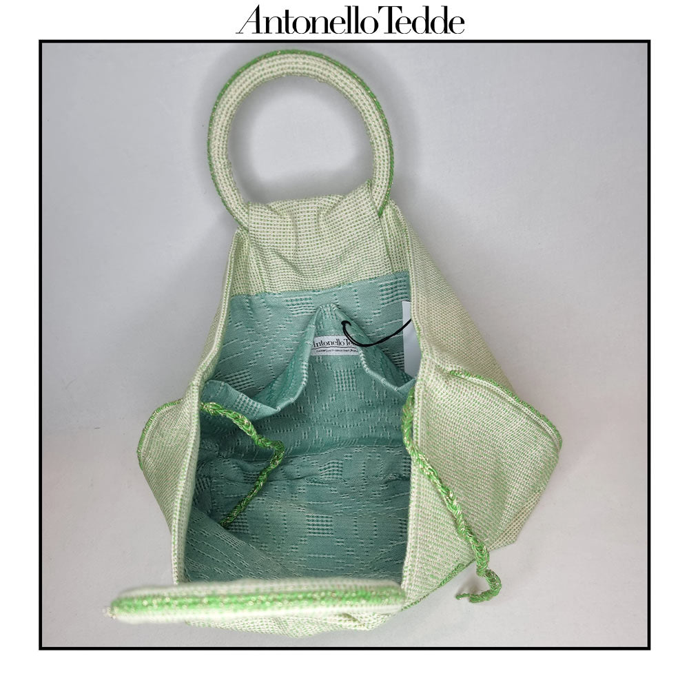 Inside view of the  handwoven green Faona tote bag with a small pibiones flower bouquet pattern and golden thread was crafted from regenerated cotton by Sardinian artisans.