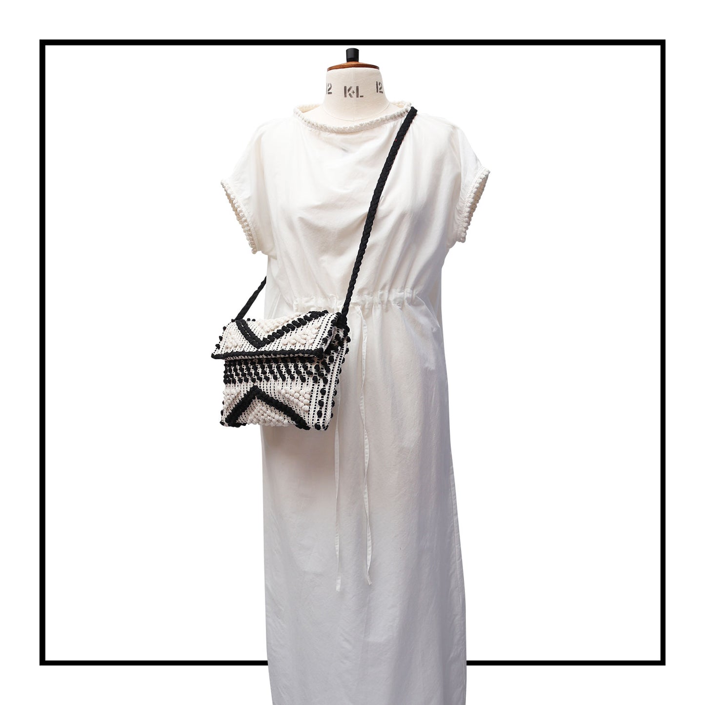 Suni Rombi Crossbody Bag by Antonello Tedde on mannequin size 12  – Handwoven Sustainable Cotton Bag in Black and Cream with Rombetti Pattern, Ethical and Timeless Italian Craftsmanship
