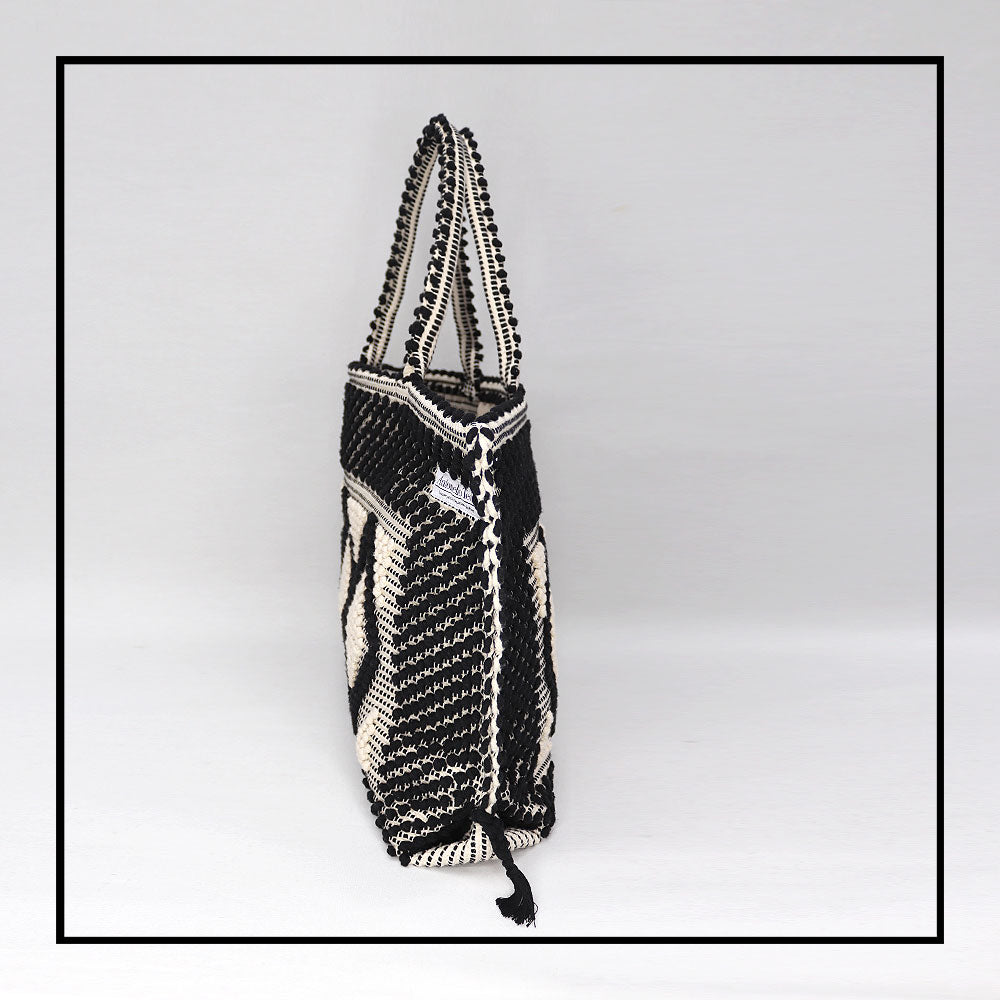 Side view of the handbag - Sustainable tote - summer bag - luxury handbag - handwoven black and white tote made in Italy by hand • timeless individualistic fashion • eco-friendly fashion • socially responsible, lasting fashion.