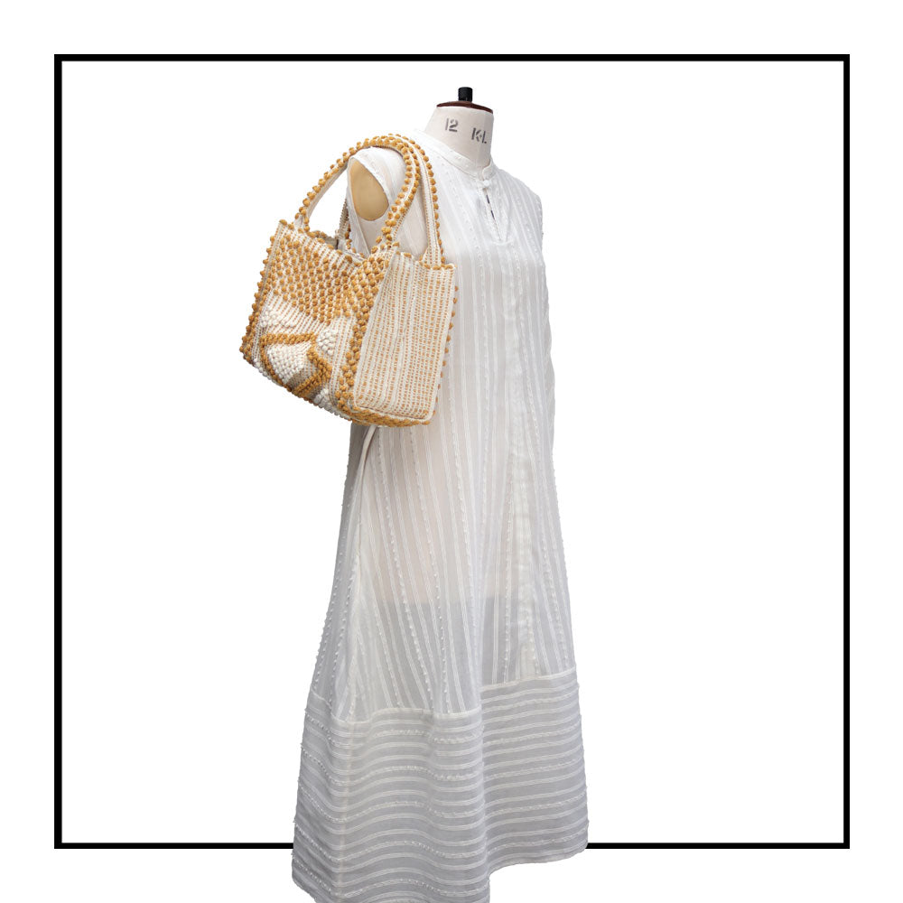 MONTE SANTU - HOBO BAG - on mannequin  MUSTARD and CREAM linen handbag -  Best eco luxury bags and accessories brand. Stylish clothes and Eco-Friendly with recycled yarns #luxury #ecoconcious #sustainablestyle  #ethicalbrands #ecoliving  #ecofashion #ecostyle #ethicalhandbags #handbags