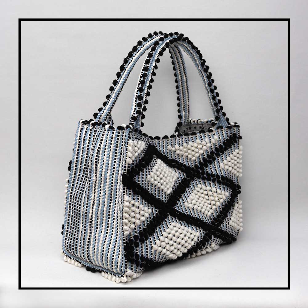 MONTE SANTU - HOBO BAG - semi side view Black and Light Blue linen handbag - Best eco luxury bags and accessories brand. Stylish clothes and Eco-Friendly with recycled yarns #luxury #ecoconcious #sustainablestyle #ethicalbrands #ecoliving #ecofashion #ecostyle #ethicalhandbags #handbags