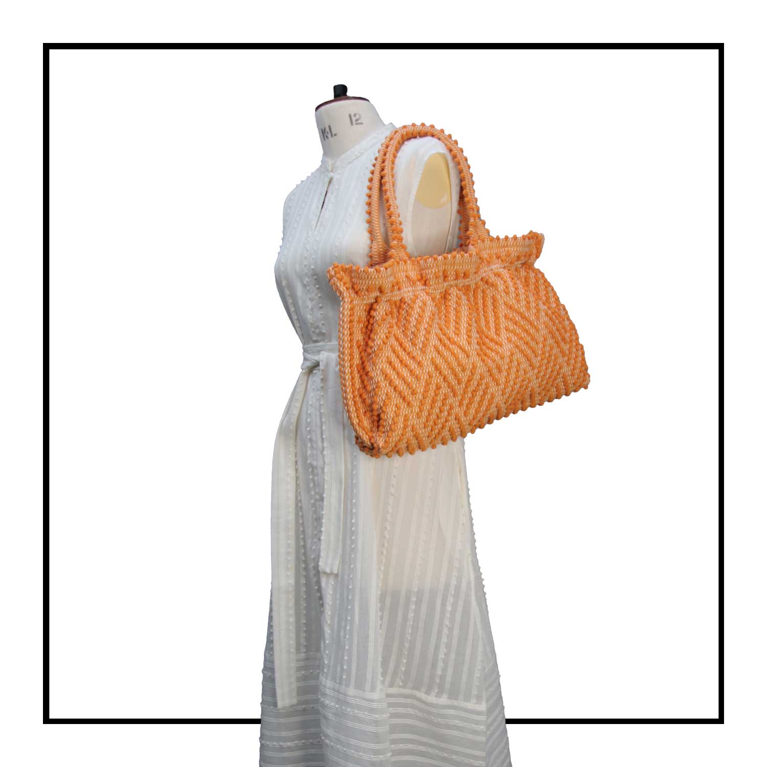 The handbag on a model - Sustainable tote - summer bag - luxury handbag - handwoven black and white tote made in Italy by hand • timeless individualistic fashion • eco-friendly fashion • socially responsible, lasting fashion.