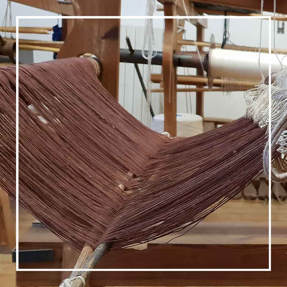 warp on loom  - Bultei_bucket bag_red flowers with white ground Best eco luxury bags and accessories brand. Stylish clothes and Eco-Friendly with recycled yarns #luxury #ecoconcious #sustainablestyle #ethicalbrands #ecoliving #ecofashion #ecostyle #ethicalhandbags #handbags