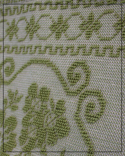 Antonello Tedde Banari Tote Bag handwoven in Sardinia using the traditional small Pibiones technique with green regenerated cotton, golden yarn, and floral bouquet motif. Close up view