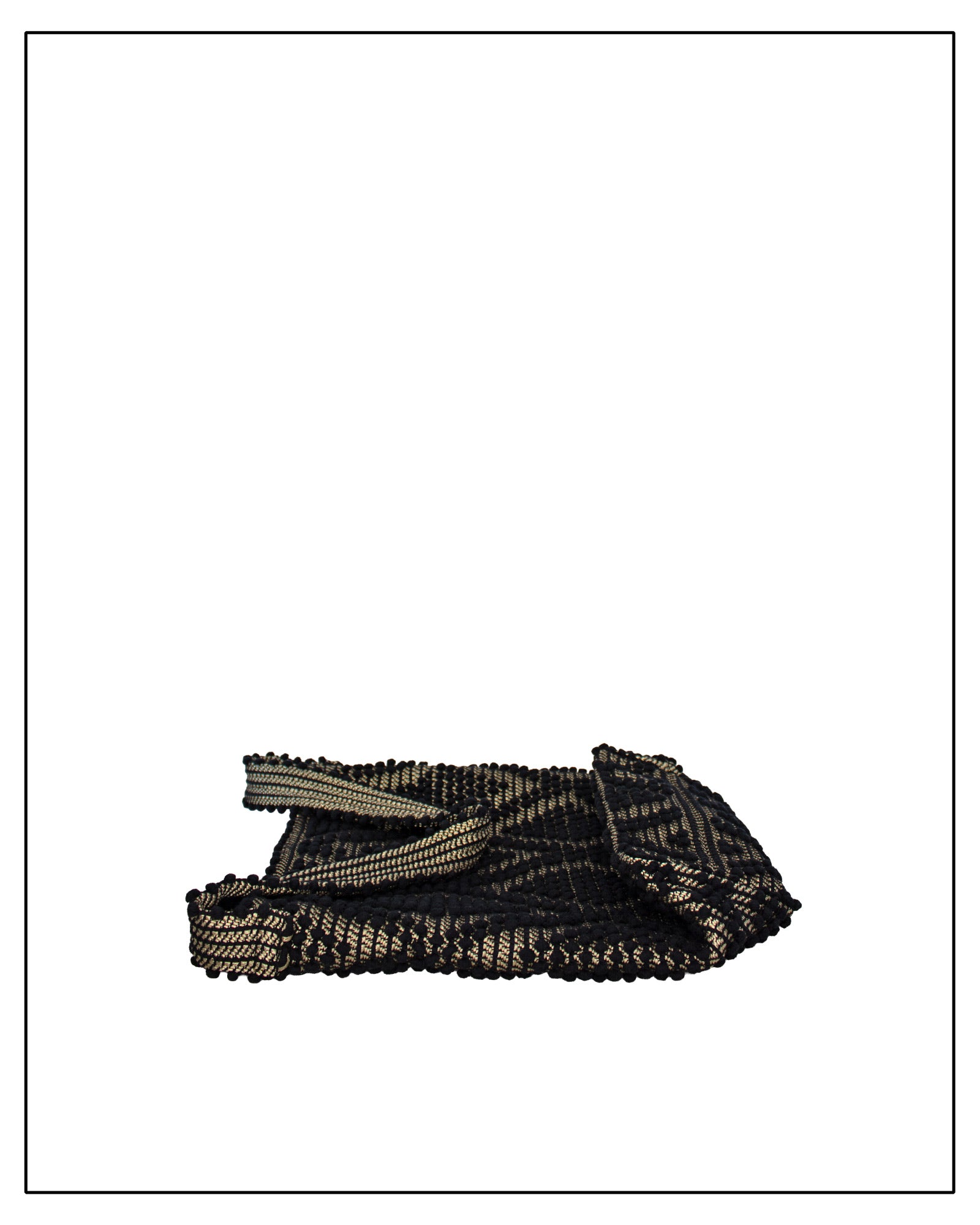 A folded Antonello Tedde Bultei Rombi shoulder bucket bag, handwoven in Sardinia from black cotton with a shimmering golden viscose diamond pattern. 