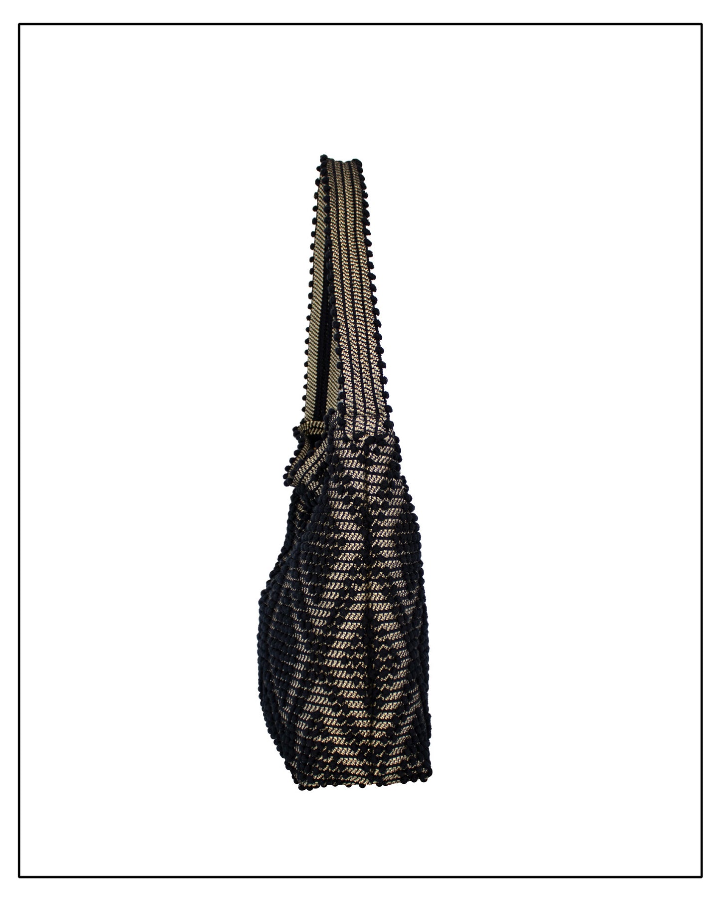 Side view of Antonello Tedde Bultei Rombi shoulder bucket bag, handwoven in Sardinia from black cotton with a shimmering golden viscose diamond pattern. 