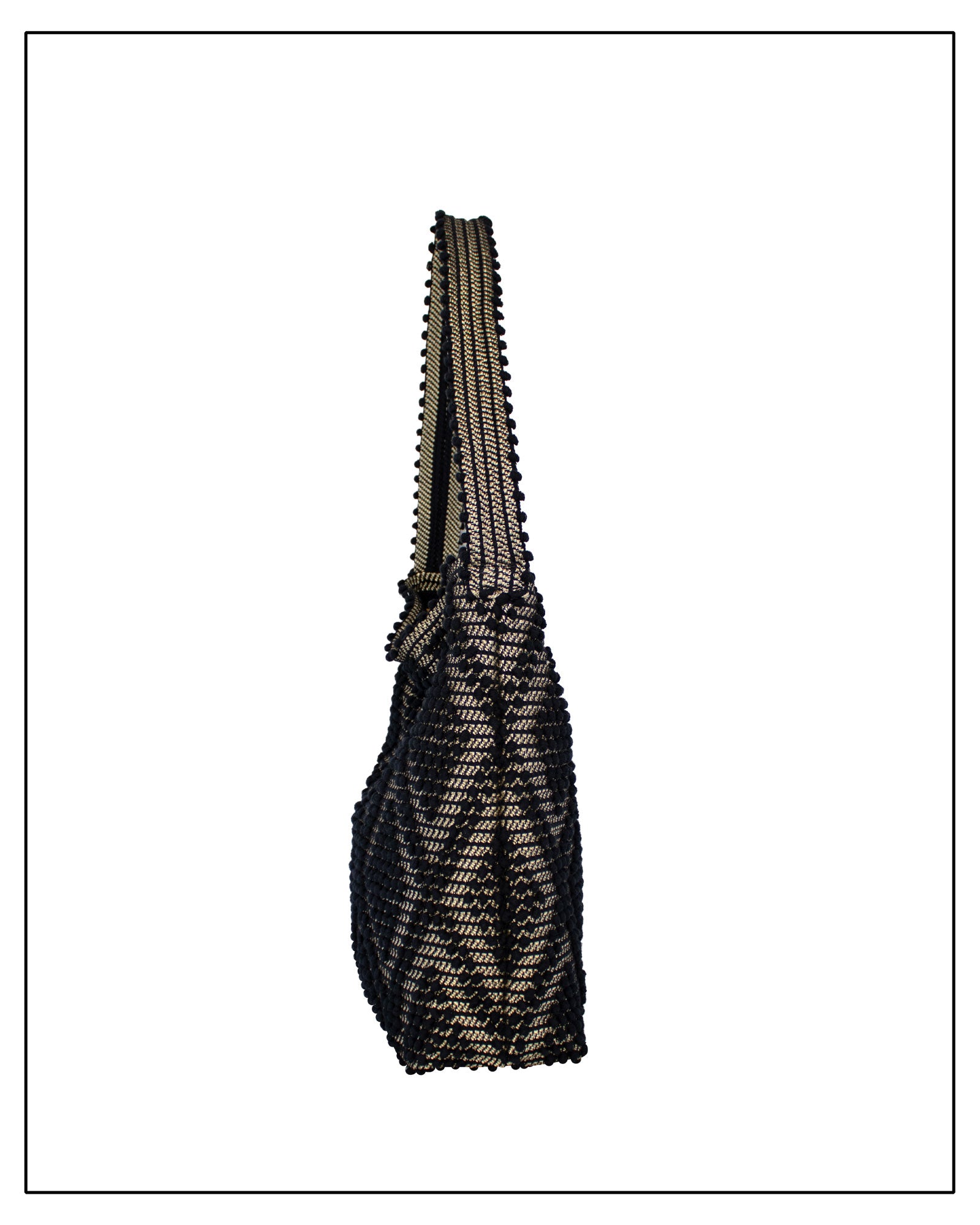 Side view of Antonello Tedde Bultei Rombi shoulder bucket bag, handwoven in Sardinia from black cotton with a shimmering golden viscose diamond pattern. 