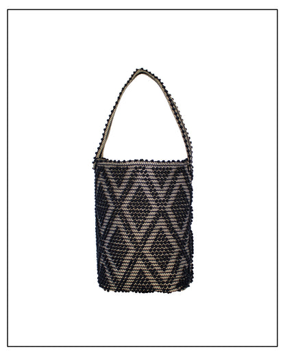 Front view of Antonello Tedde Bultei Rombi bucket bag, handwoven in Sardinia from black cotton with a shimmering golden viscose diamond pattern.