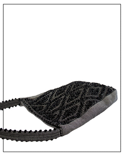 Flat view of Antonello Tedde Bultei handwoven tote bag in black cotton with subtle silver highlights and textured woven front panel, handcrafted in Sardinia.