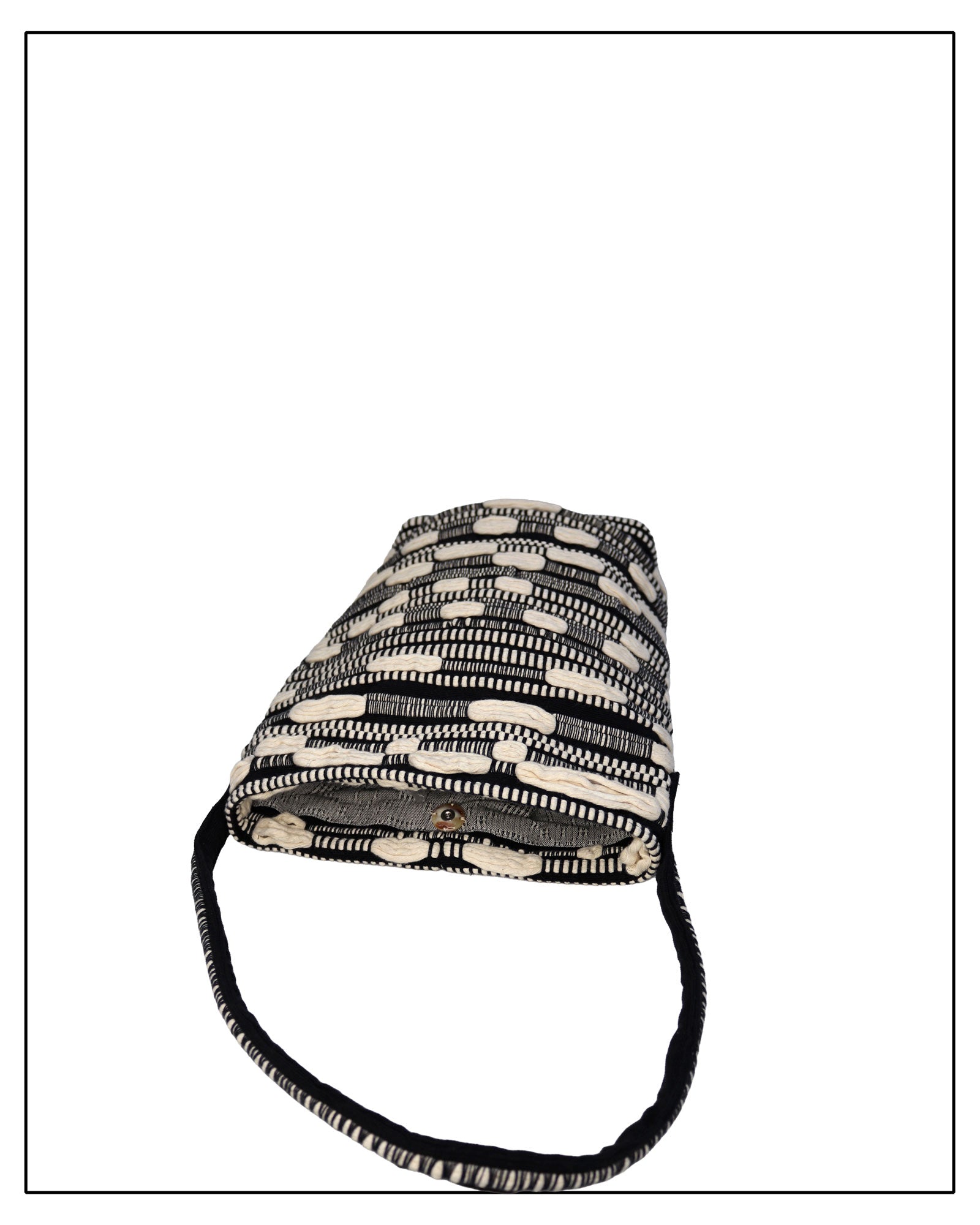 Flat Mouth View of Antonello Tedde Bultei Tote Bag from the Trame in Fuga Collection, handwoven in Sardinia with black and natural cotton, textured woven motifs, and artisanal craftsmanship.