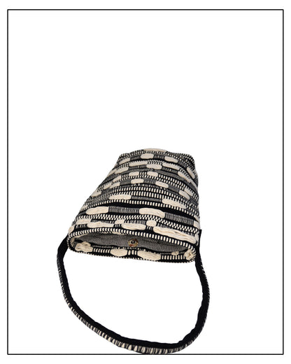 Flat Mouth View of Antonello Tedde Bultei Tote Bag from the Trame in Fuga Collection, handwoven in Sardinia with black and natural cotton, textured woven motifs, and artisanal craftsmanship.