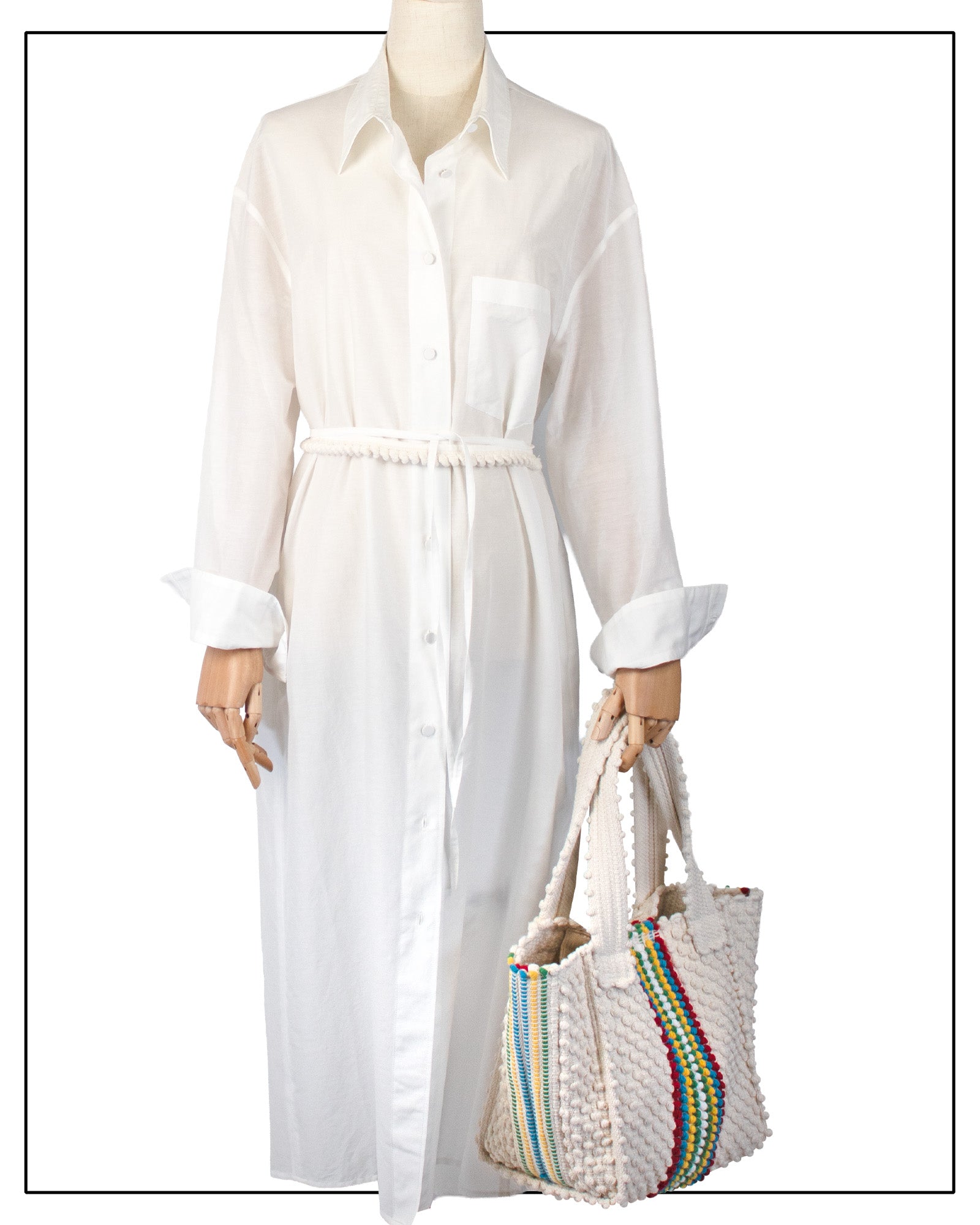 Mannequin wearing a white dress holding a colourful bag on a white background - Pula Medium Tote Bag, a reimagined classic that marks the return of the beloved striscie (stripes) pattern in a fresh, contemporary silhouette.