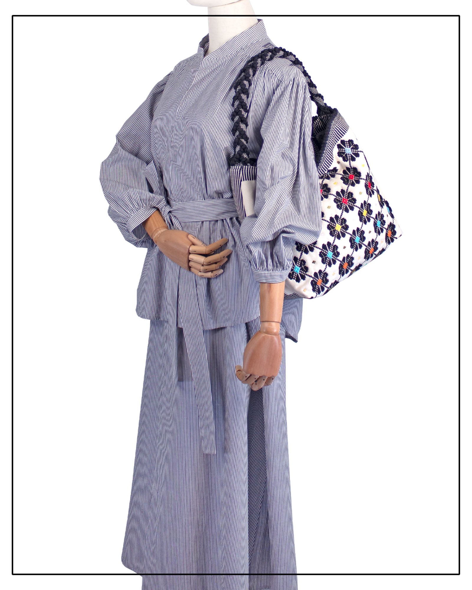 Floral-patterned bag with a black handle on a white background