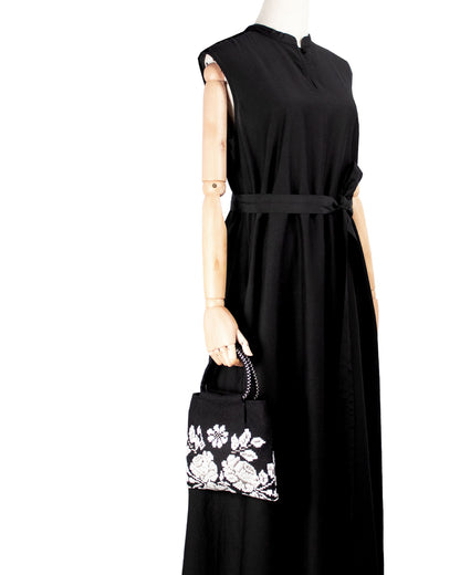 on a model with a black dress, the black and white evening bag to complete your look with our selection of accessories crafted with the environment in mind