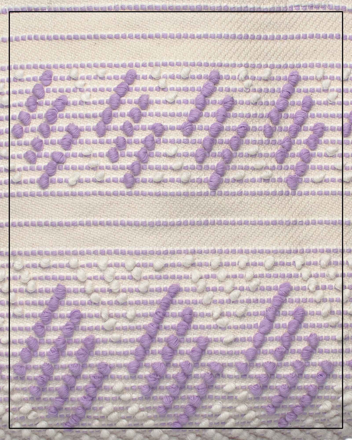 Antonello Tedde Mugoni Zig Zag Tote Bag, handwoven in Sardinia from linen and cotton with geometric zig zag weave and diamond motifs - close up view of tote bag with purple on a cream background