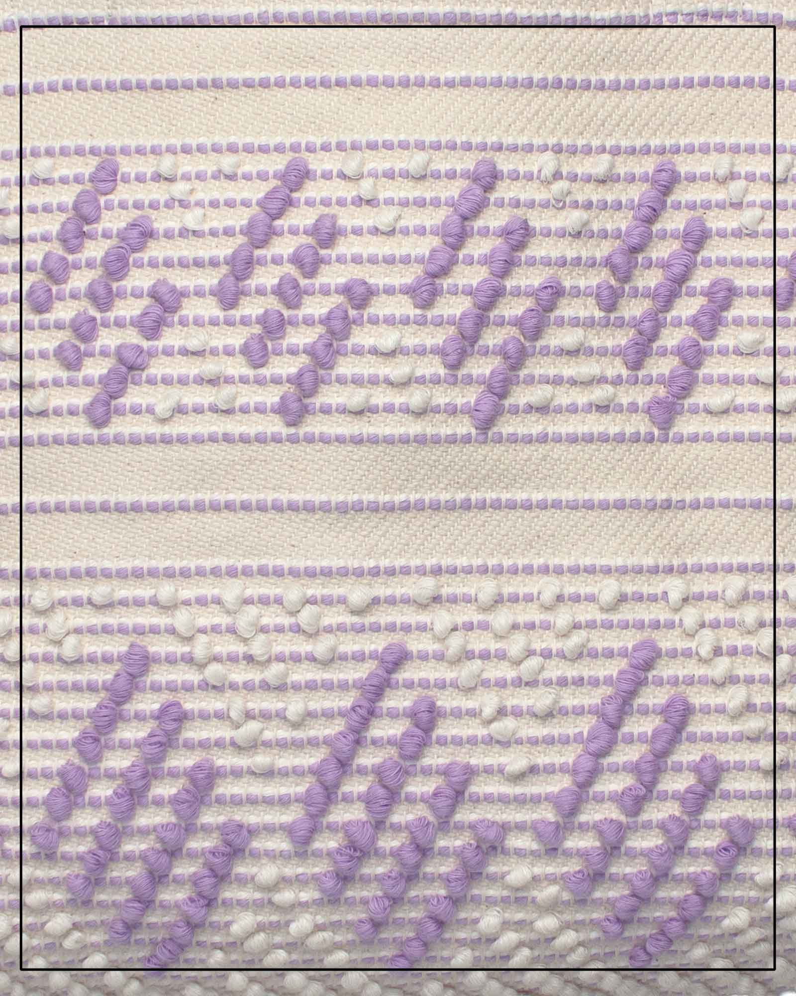 Antonello Tedde Mugoni Zig Zag Tote Bag, handwoven in Sardinia from linen and cotton with geometric zig zag weave and diamond motifs - close up view of tote bag with purple on a cream background