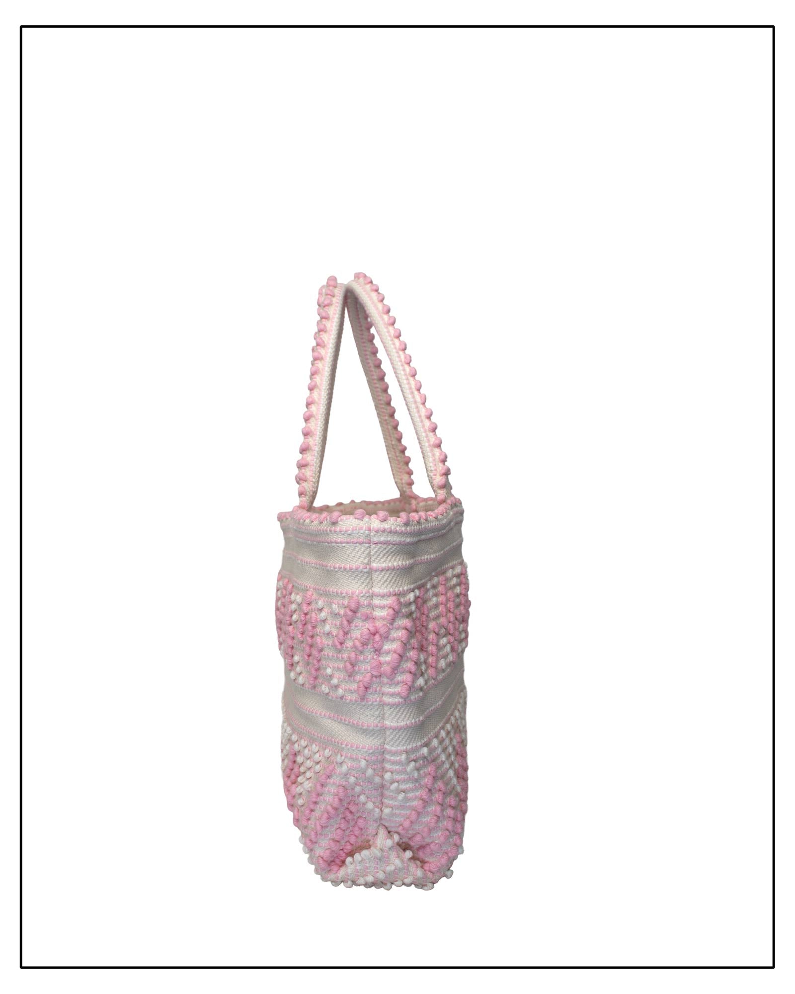 Antonello Tedde Mugoni Zig Zag Tote Bag, handwoven in Sardinia from linen and cotton with geometric zig zag weave and diamond motifs - side view of tote bag with pink on a cream background