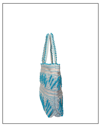 Antonello Tedde Mugoni Zig Zag Tote Bag, handwoven in Sardinia from linen and cotton with geometric zig zag weave and diamond motifs - Side view of tote bag with turquoise on a cream background