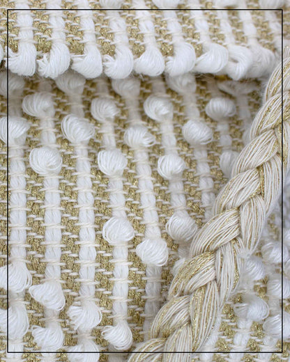 Close up view of an Antonello Tedde Suni Small crossbody bag handwoven in Sardinia in cream Italian linen, ivory and subtle golden yarn with braided strap. 