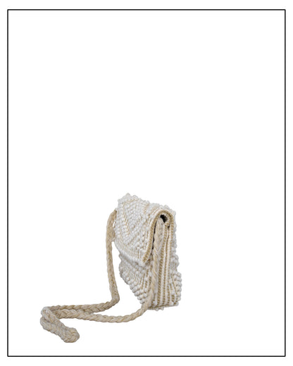 Side view of an Antonello Tedde Suni Small crossbody bag handwoven in Sardinia in cream Italian linen, ivory and subtle golden yarn with braided strap.