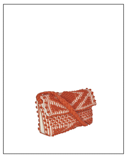 Side view of Antonello Tedde Suni Square crossbody bag handwoven in Sardinia in coral and cream cotton with raised geometric pattern and braided strap