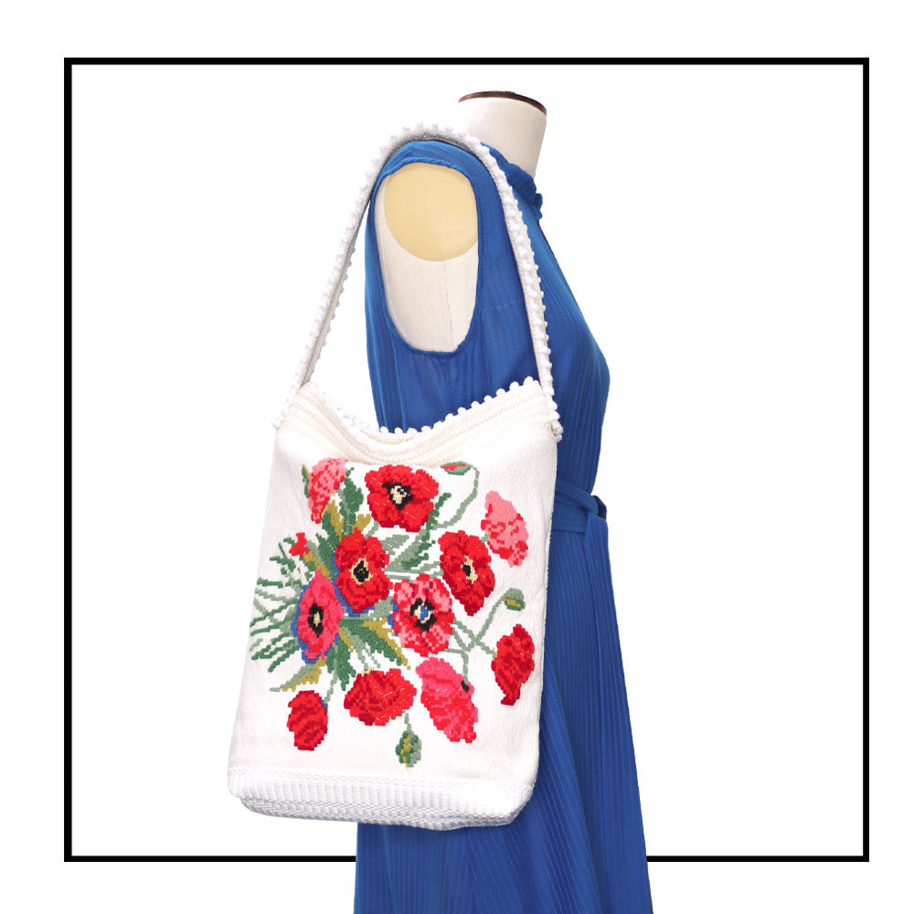 on stand with denim ANTOTE dress -Bultei_bucket bag_red flowers with white ground Best eco luxury bags and accessories brand. Stylish clothes and Eco-Friendly with recycled yarns #luxury #ecoconcious #sustainablestyle #ethicalbrands #ecoliving #ecofashion #ecostyle #ethicalhandbags #handbags