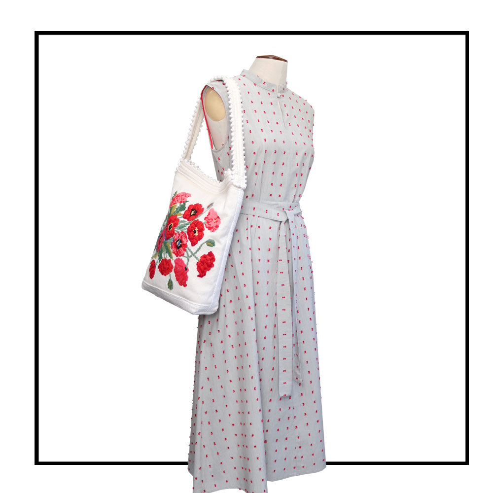 bag on stand matched with plume ANTOTE dress Bultei_bucket bag_red flowers with white ground Best eco luxury bags and accessories brand. Stylish clothes and Eco-Friendly with recycled yarns #luxury #ecoconcious #sustainablestyle #ethicalbrands #ecoliving #ecofashion #ecostyle #ethicalhandbags #handbags