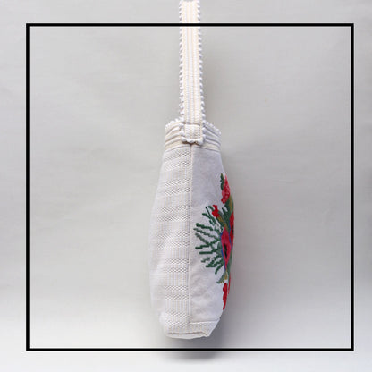 Side view of Bultei_bucket bag_red flowers with white ground Best eco luxury bags and accessories brand. Stylish clothes and Eco-Friendly with recycled yarns #luxury #ecoconcious #sustainablestyle #ethicalbrands #ecoliving #ecofashion #ecostyle #ethicalhandbags #handbags