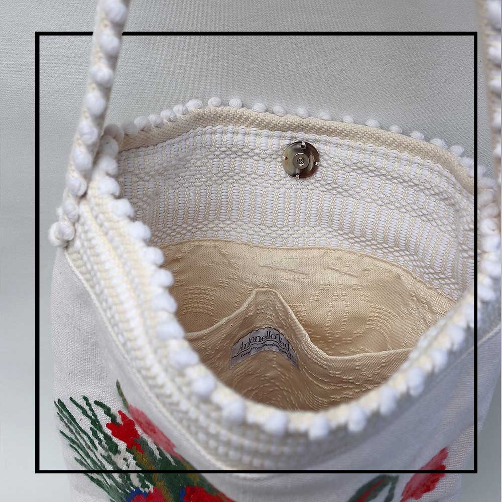 Inside lining and magnet view of Bultei_bucket bag_red flowers with white ground Best eco luxury bags and accessories brand. Stylish clothes and Eco-Friendly with recycled yarns #luxury #ecoconcious #sustainablestyle #ethicalbrands #ecoliving #ecofashion #ecostyle #ethicalhandbags #handbags