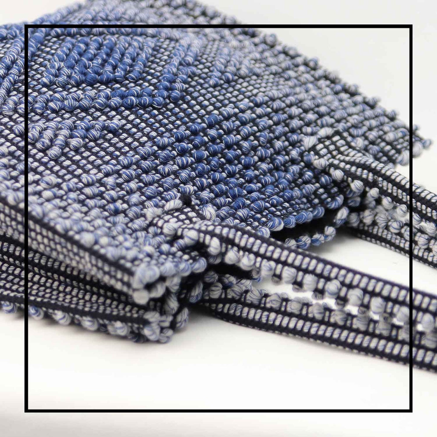 DETAIL TOP VIEW OF MELANGE BLUE with BLACK GROUND SQUARE TOTE bag to complete your look with our selection of accessories crafted with the environment in mind