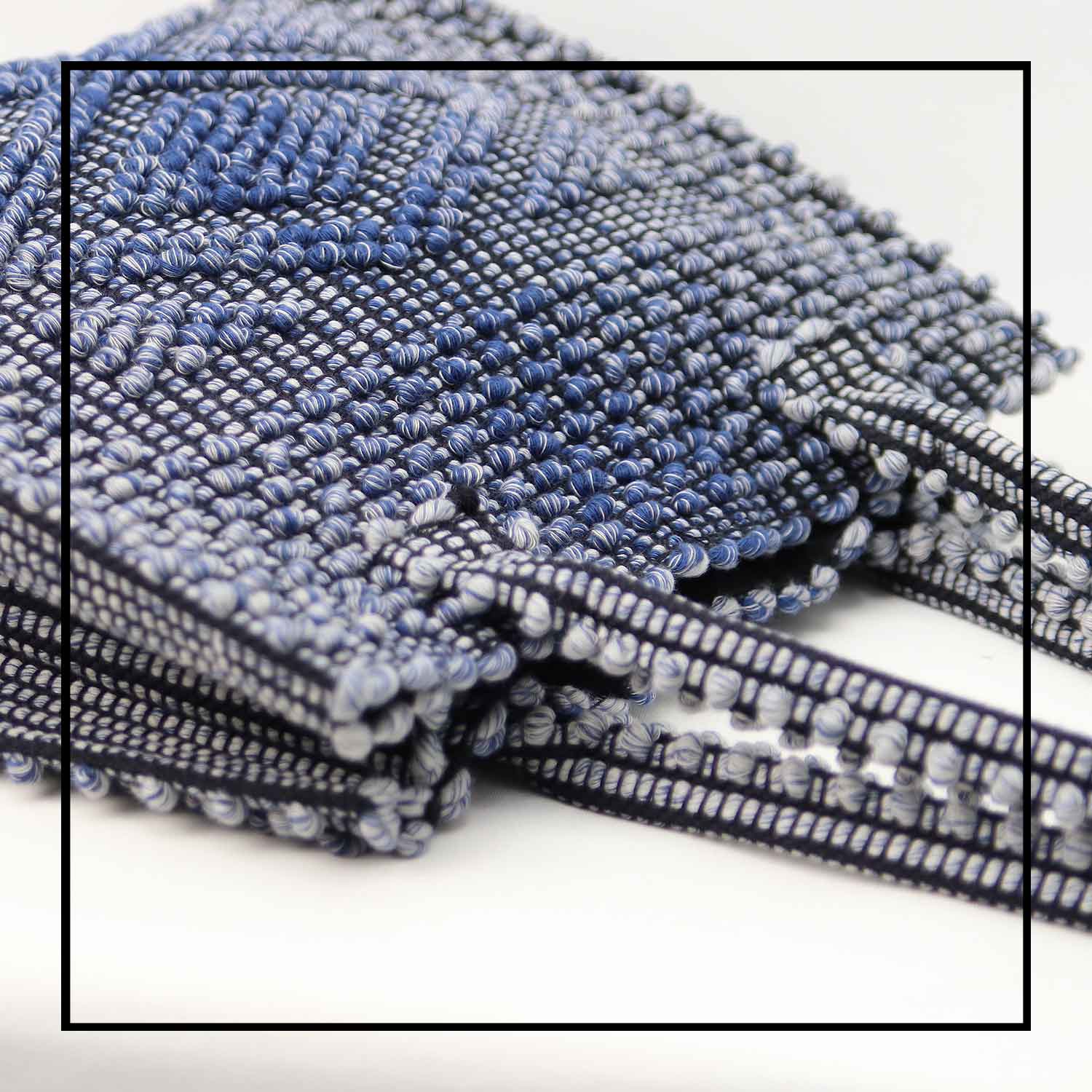 DETAIL TOP VIEW OF MELANGE BLUE with BLACK GROUND SQUARE TOTE bag to complete your look with our selection of accessories crafted with the environment in mind