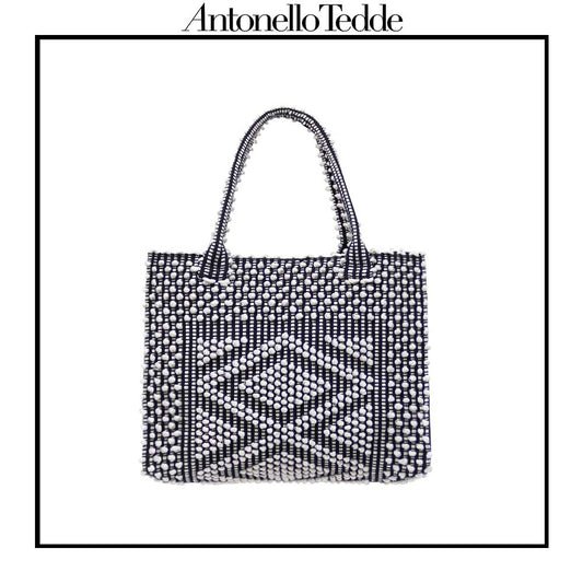 Main frontal view of the black and white tote bag. Sustainable tote - summer bag - luxury handbag - handwoven black and white tote made in Italy by hand • timeless individualistic fashion • eco-friendly fashion • socially responsible, lasting fashion